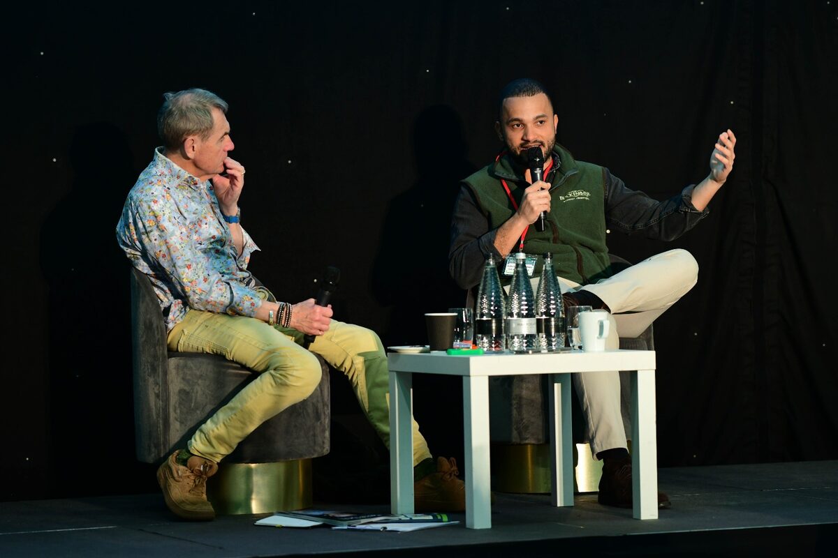 Alex in a fireside chat on stage