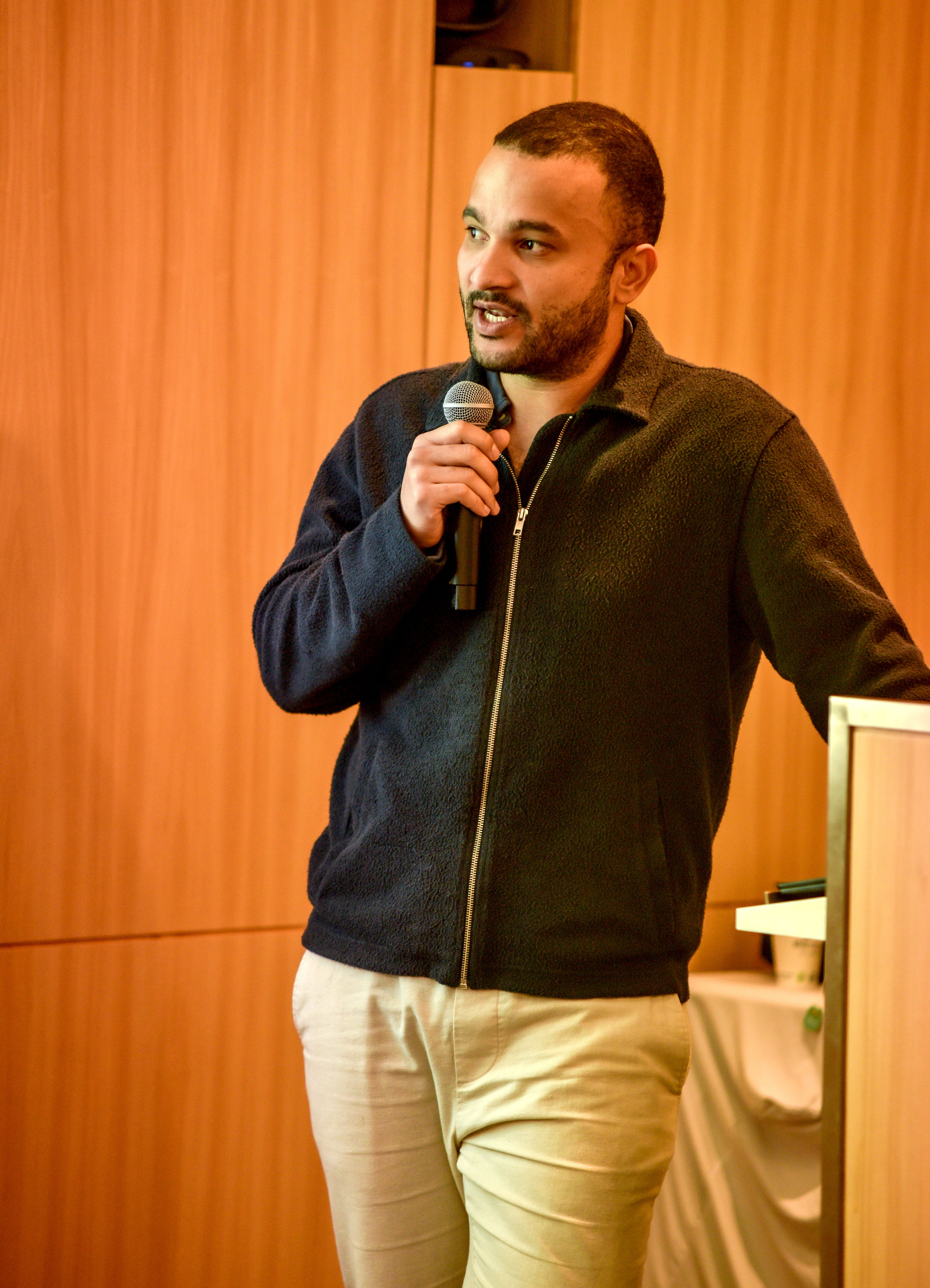 Alex speaking with a microphone
